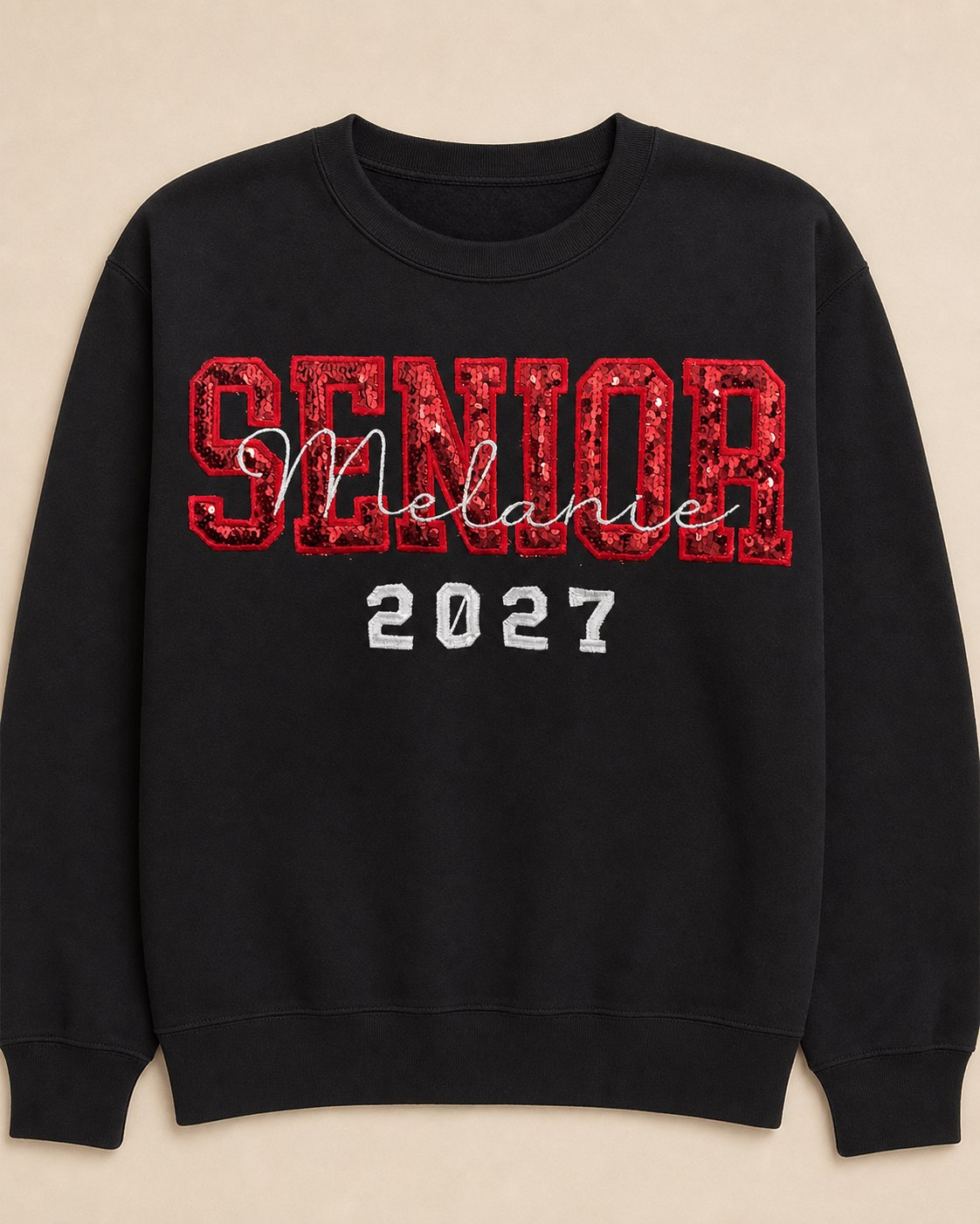 Black Senior 2027 sweatshirt with red sequin appliqué and a personalized script name.